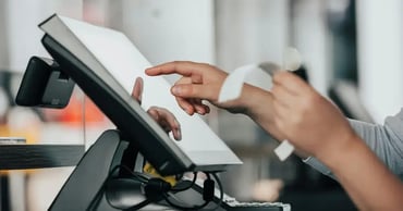 liquor store owner using POS system